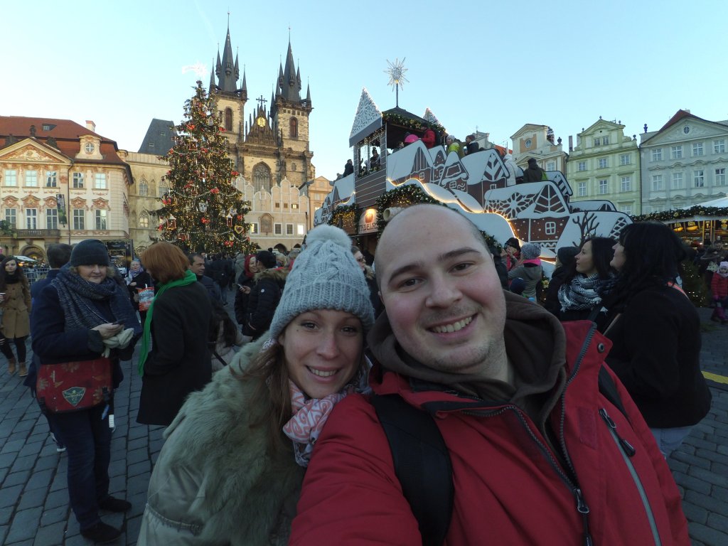travel couple exploring Christmas markets in city center of Prague